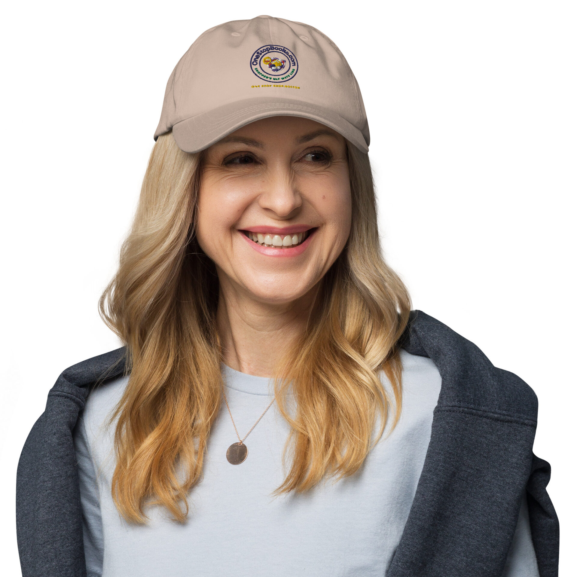 Woman smiling wearing a brown cap.