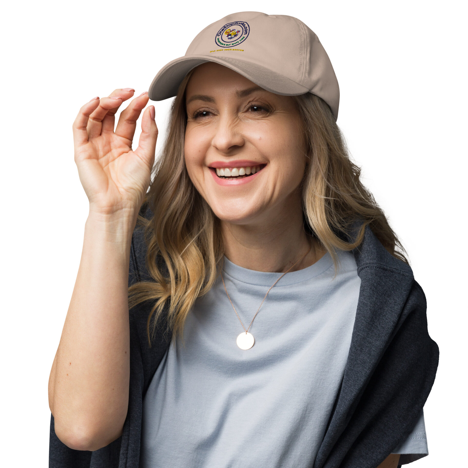 Woman smiling with a beige cap on.