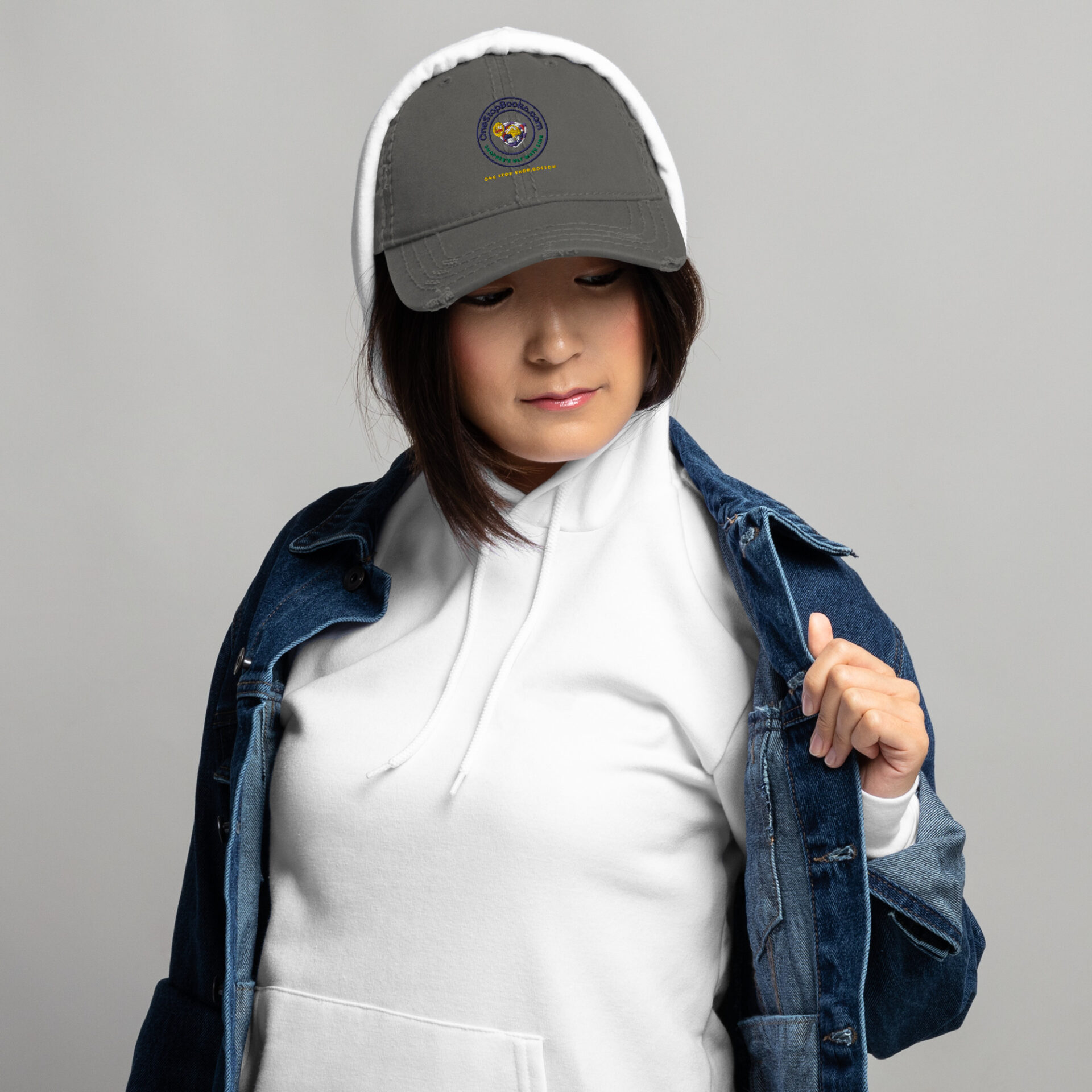 Woman wearing a grey distressed cap.