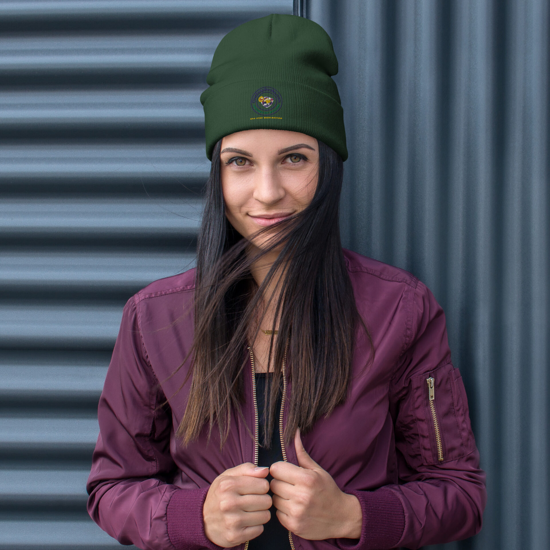Woman in green beanie and purple jacket.