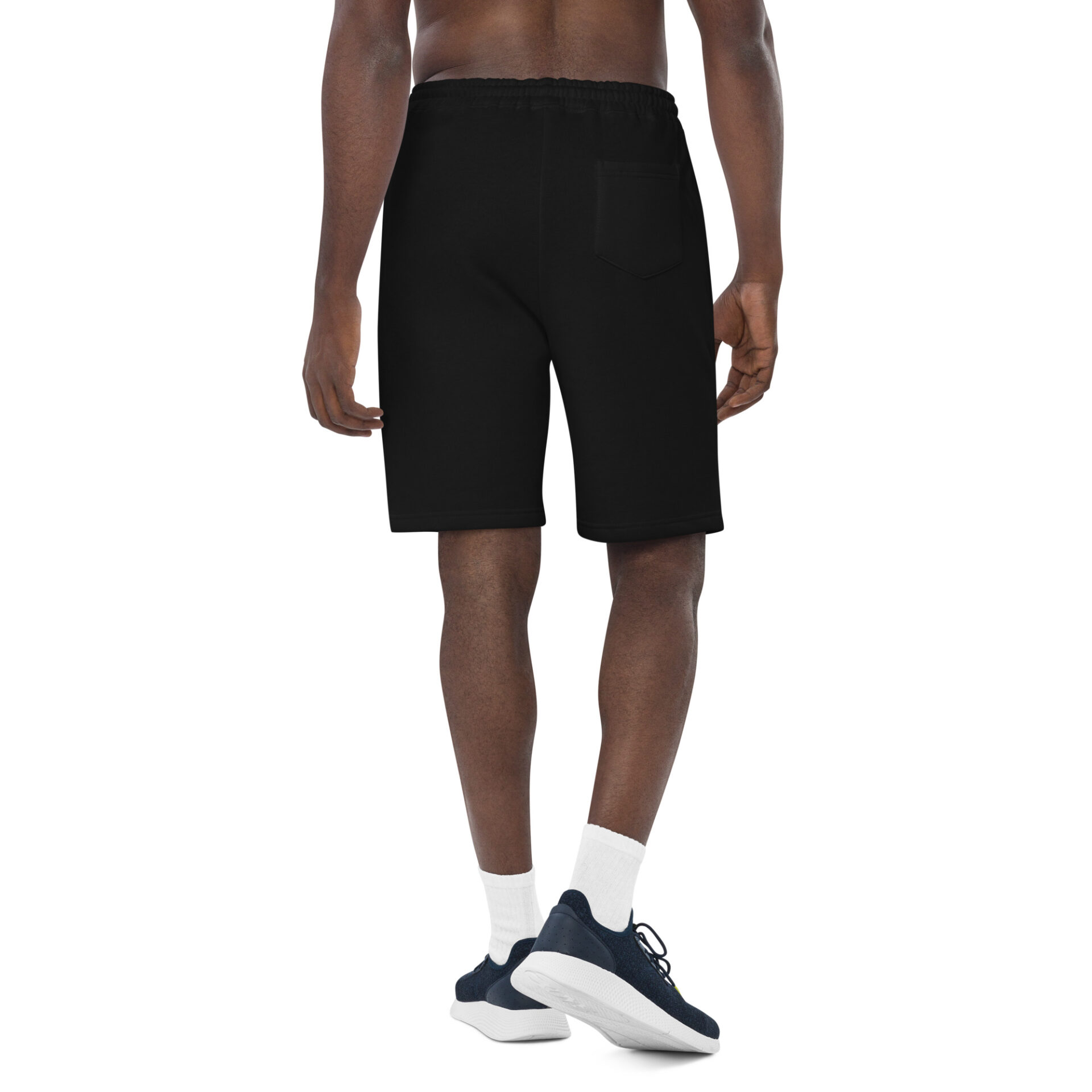 Man wearing black sweatshorts and sneakers.