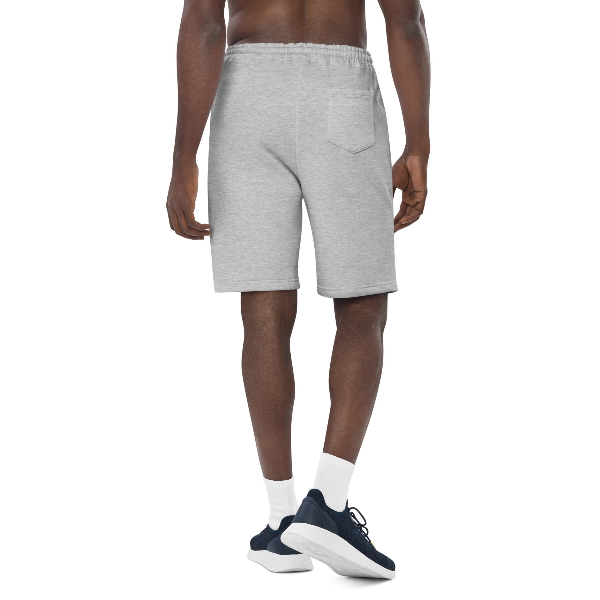 Man wearing grey sweatpants and sneakers.