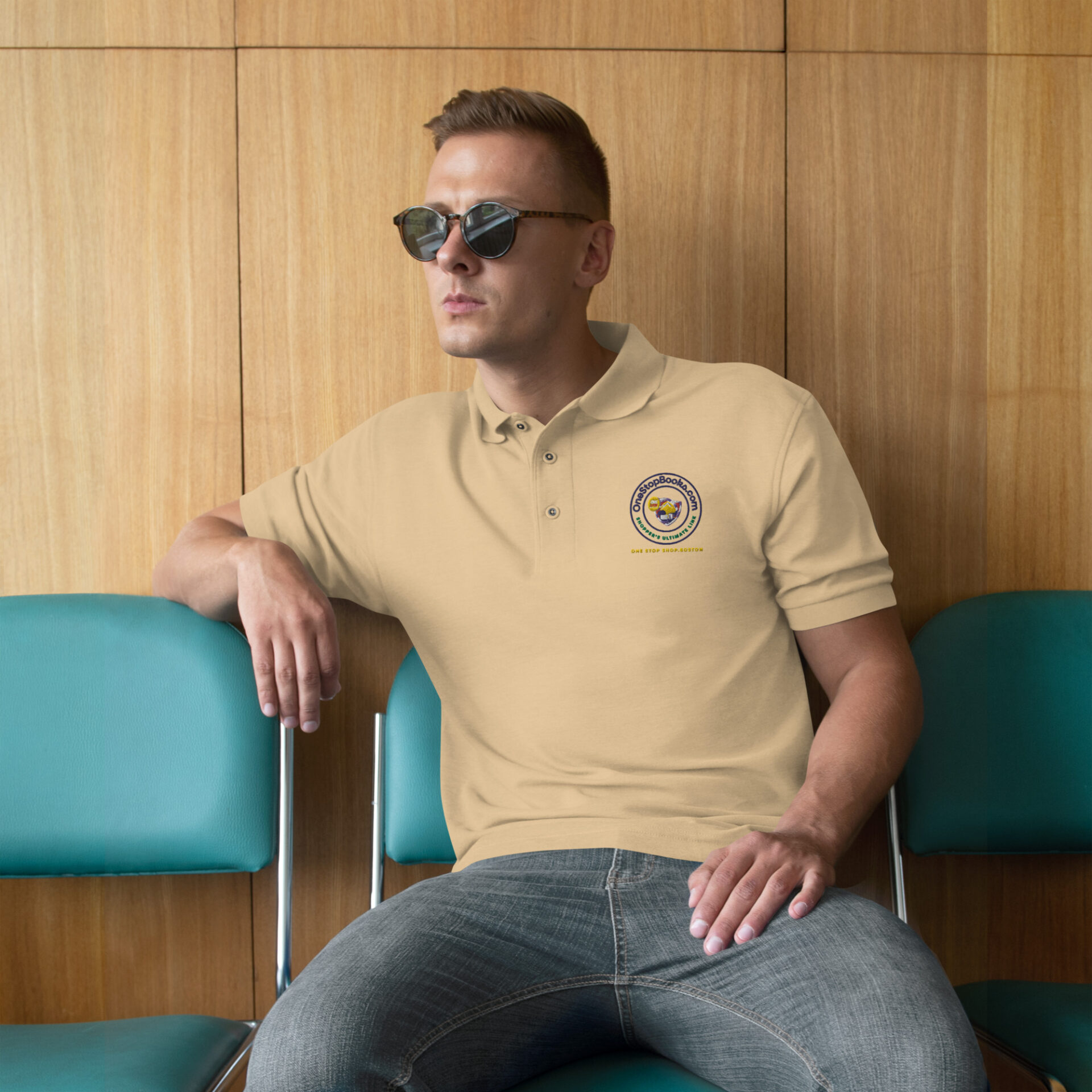 Man wearing tan polo with logo, sitting.