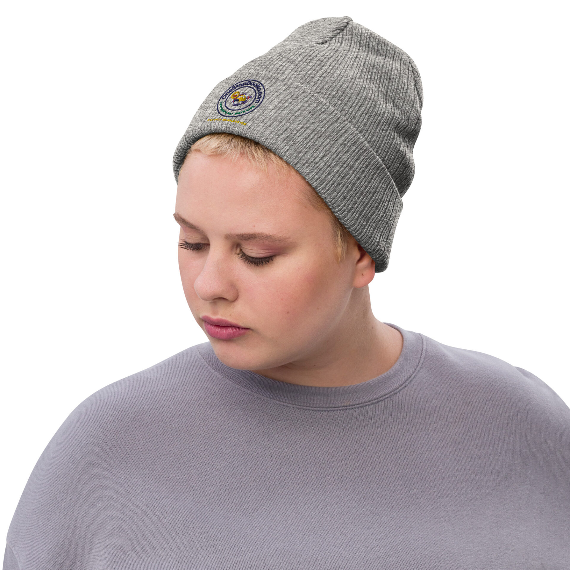 Person wearing gray beanie with logo.