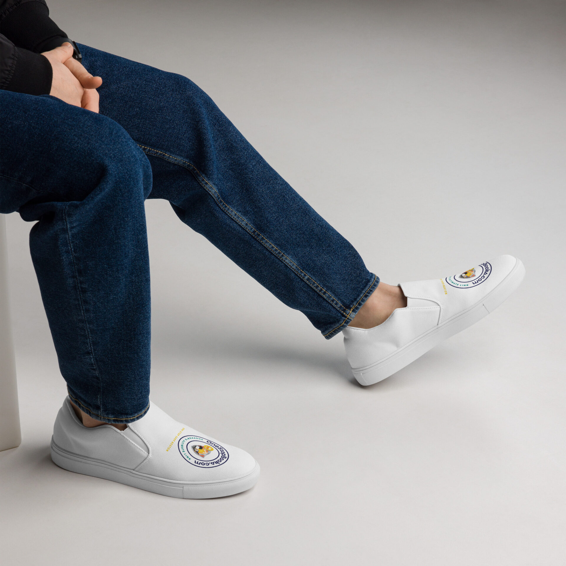 Person wearing white shoes with logo.
