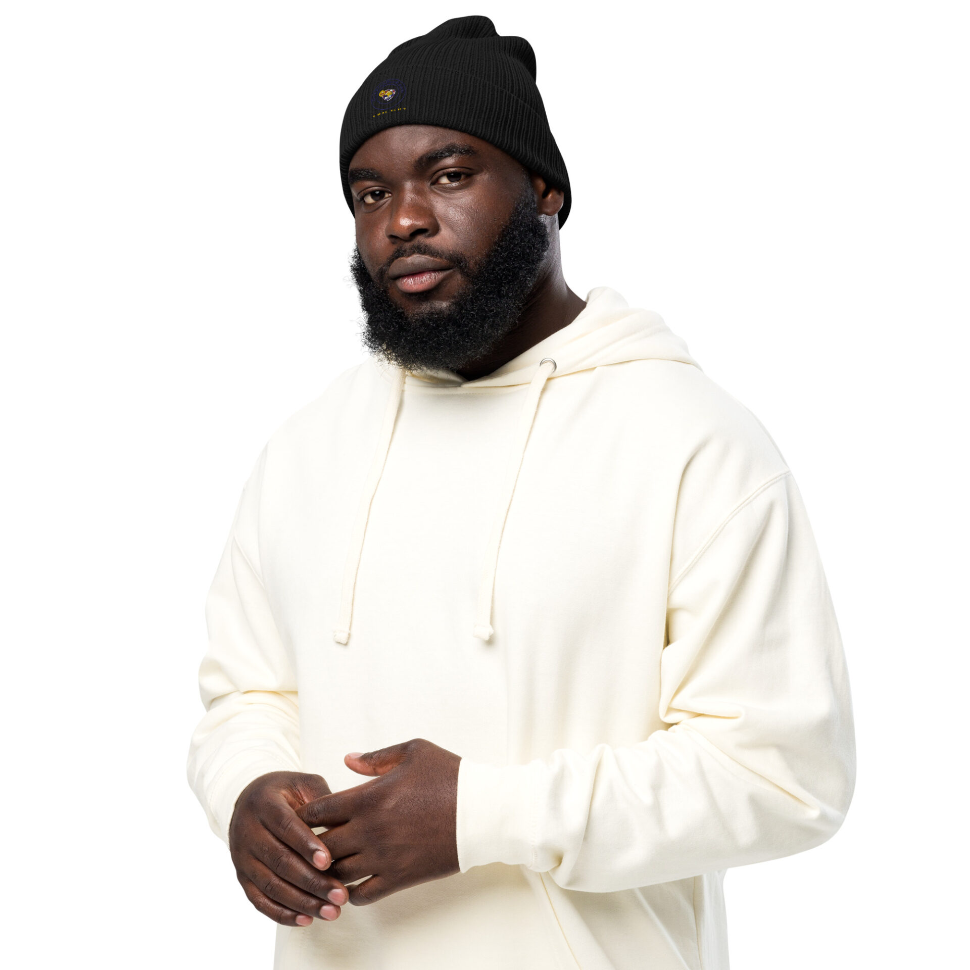 Man wearing a black beanie and white hoodie.