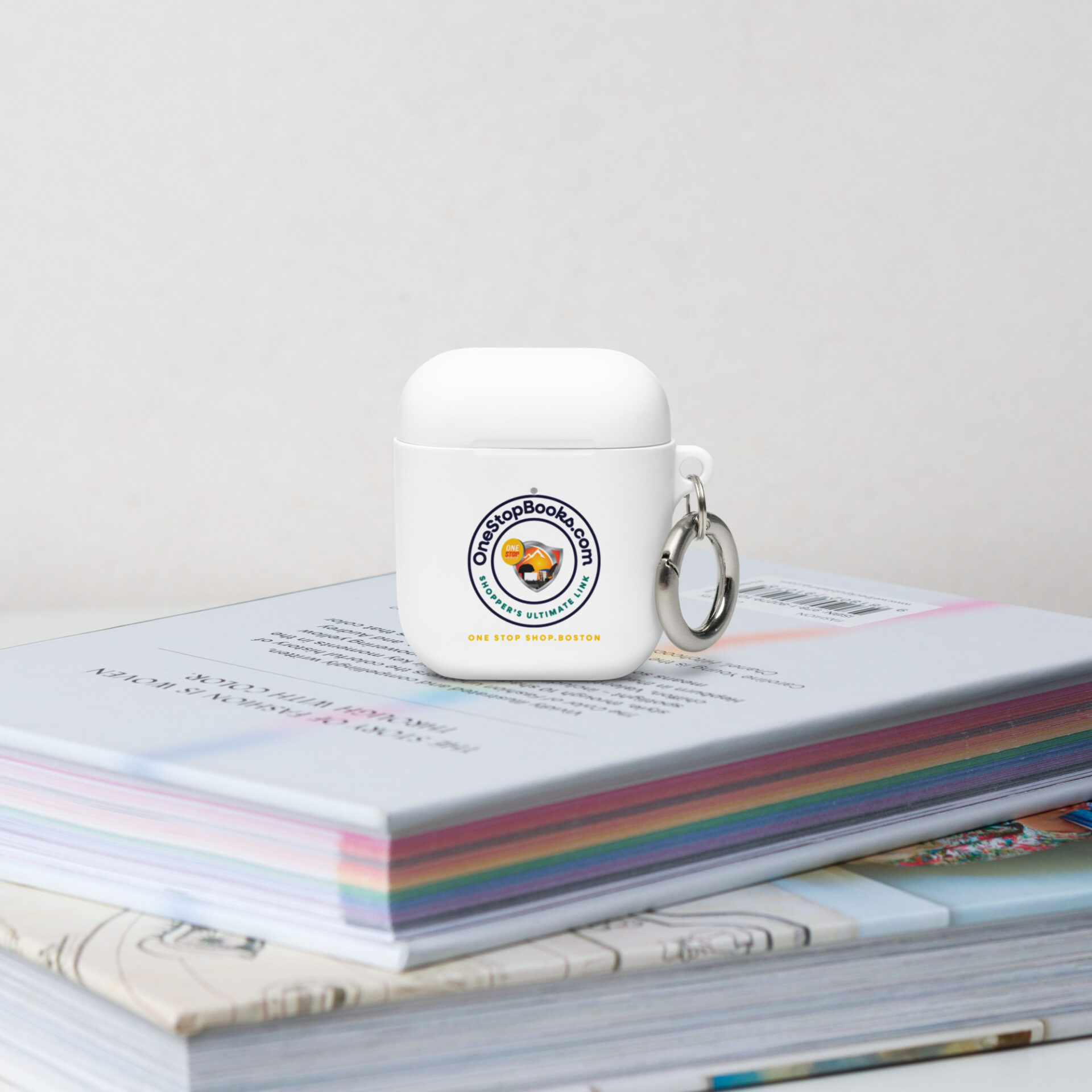 White Airpods case with OneStopBooks.com logo.